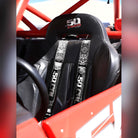Black Sugar Skull | 50 Caliber Racing elite series black sugar skull 4 point utv harness installed in polaris rzr bucket seat