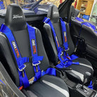 Nitro Blue | Blue 4-point UTV harness, 3" main straps, latch-style quick release, shown installed in Kawasaki KRX