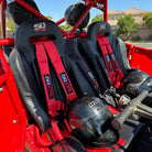 Rage Red | Red 4-point UTV harness, 3" main straps, latch-style quick release, shown installed in Polaris RZR