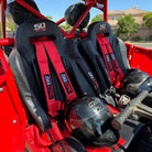 Rage Red | Red 4-point UTV harness, 3" main straps, latch-style quick release, shown installed in Polaris RZR