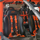 Blaze Orange | Orange | 50 Caliber Racing Pro Series 4-point UTV harness installed on UTV seat Orange