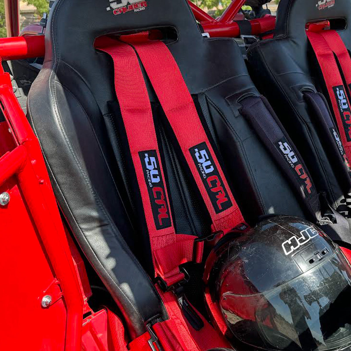 Rage Red | 50 Caliber Racing Elite Series Red 4 point utv harness installed in polaris rzr bucket seat